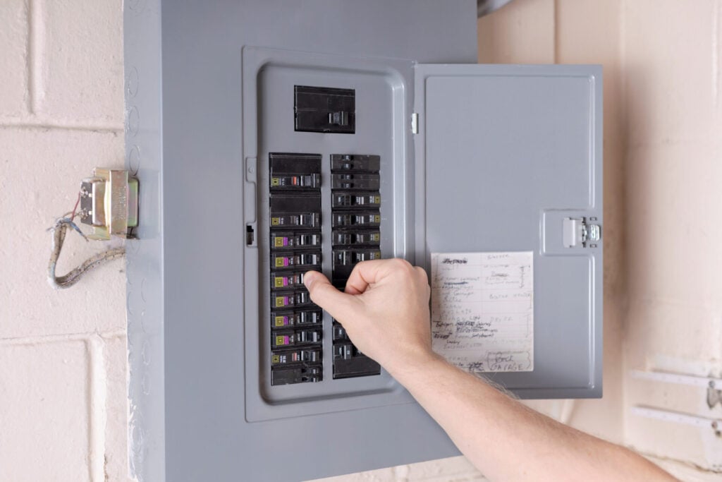 Electrician inspecting an electrical panel for necessary upgrades in a Palatine home.