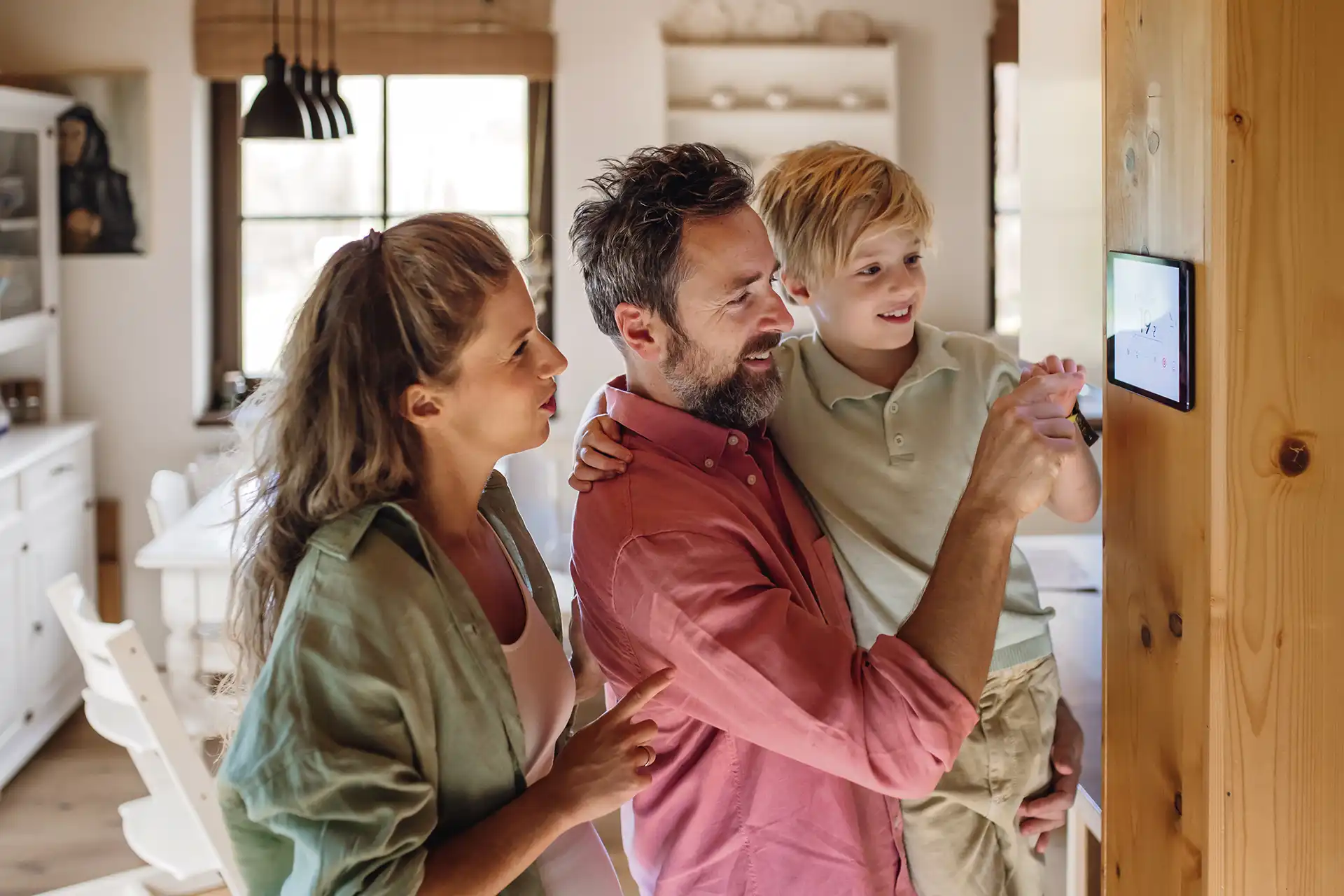 family controlling home automation via smart thermostat
