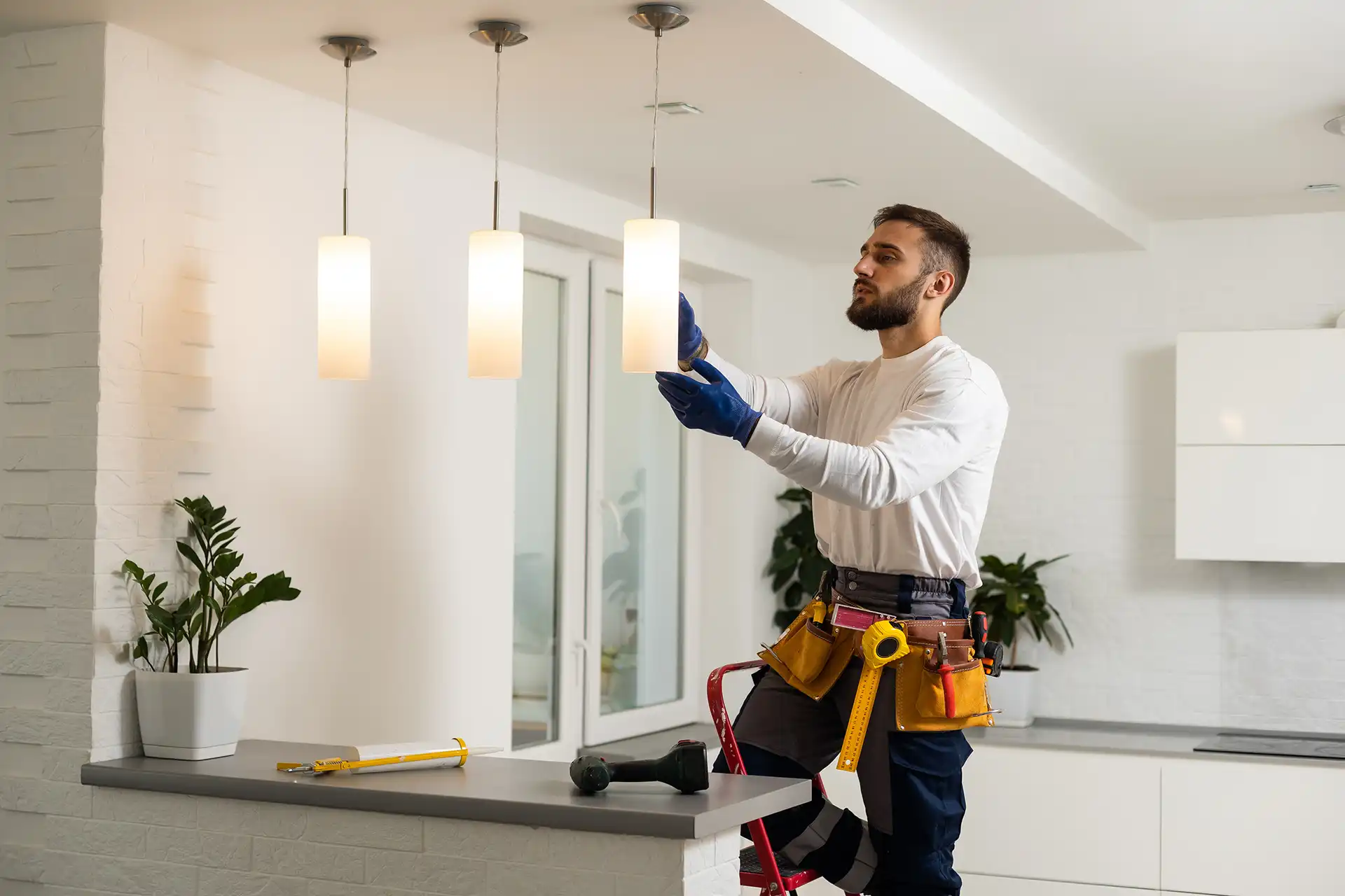 electrician installing kitchen lighting