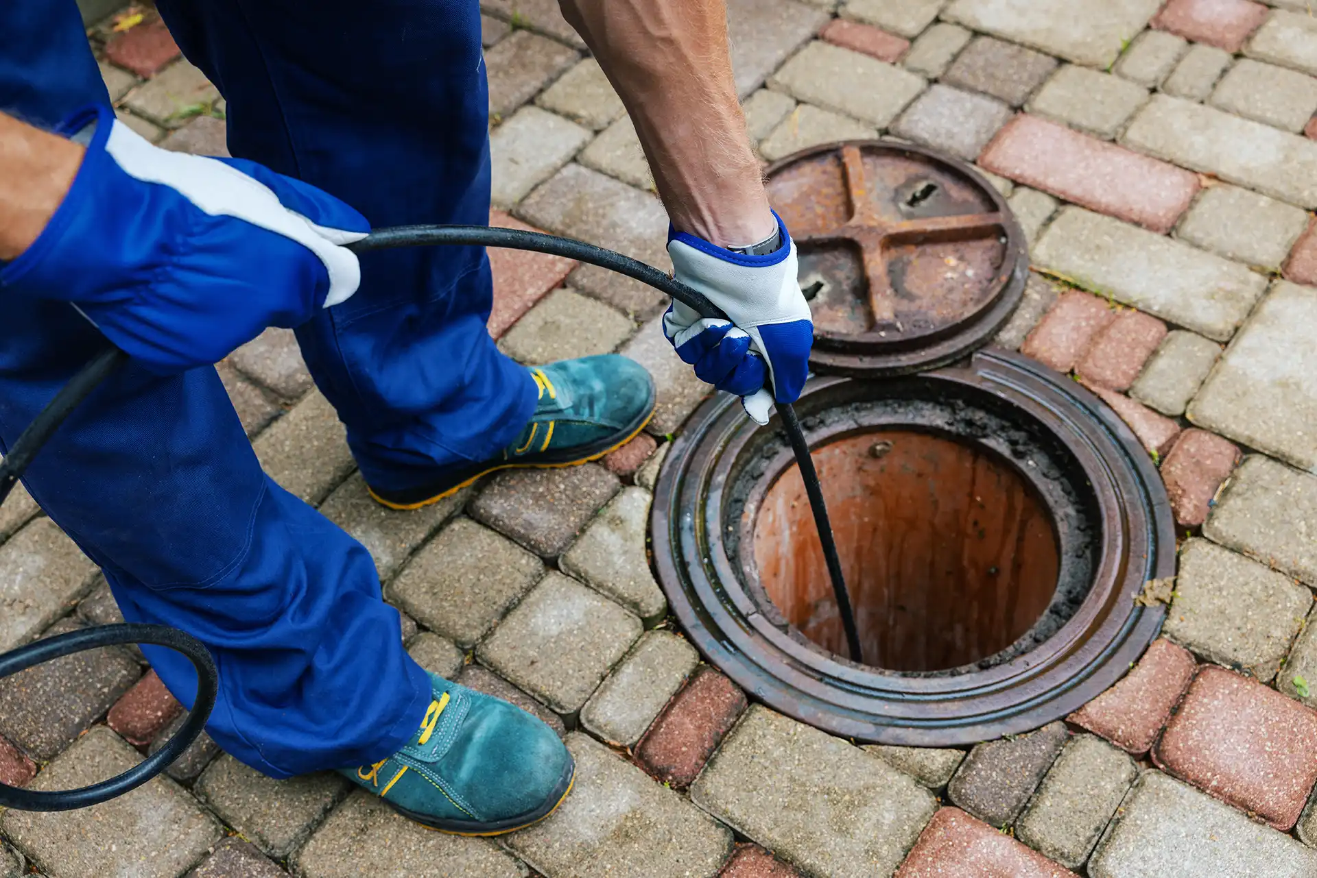 sewer cleaning by plumber in progress
